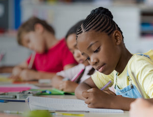 Students writing in notebooks